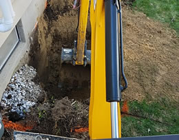 Digging Alongside A Foundation To Install An Egress Window.